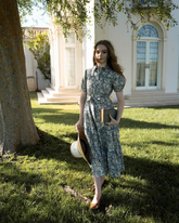 a lady wears a floral printed lapel tiered midi dress